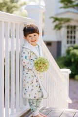 White Madame Butterfly bathrobe for 1-2 years, made by Timo & Violet, shown hanging with soft fabric and plush texture.