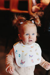 Timo & Violet Madame Butterfly bib in multi-color with butterfly pattern, soft fabric for baby comfort.