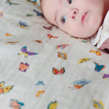 Timo & Violet Madame Butterfly Shawl Blanket in colorful, patterned fabric, draped over a surface showing its vibrant design.