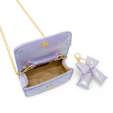 Shiny purple quilted fluffy bow handbag by Tiny Treats and ZOMI GEMS with a decorative bow and quilted design.