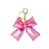 Shiny purple quilted fluffy bow handbag by Tiny Treats and ZOMI GEMS with soft textured surface and stylish design.