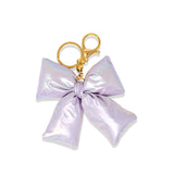Purple shiny quilted fluffy bow handbag by Tiny Treats and ZOMI GEMS, featuring a stylish quilted design and plush bow detail.