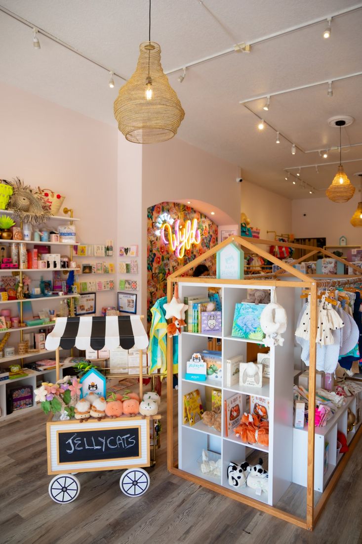 Inside A Little Wyld boutique with baby gifts, Jellycat and a neon Wyld sign