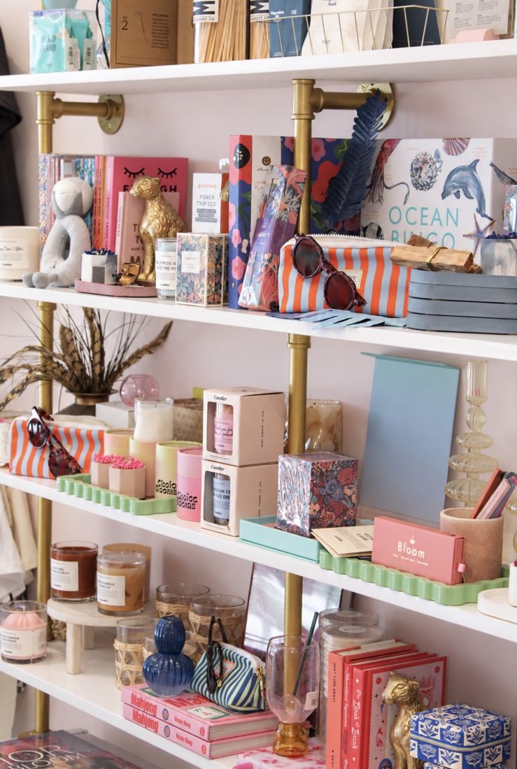 Boutique shelves styled with gifts, candles and books